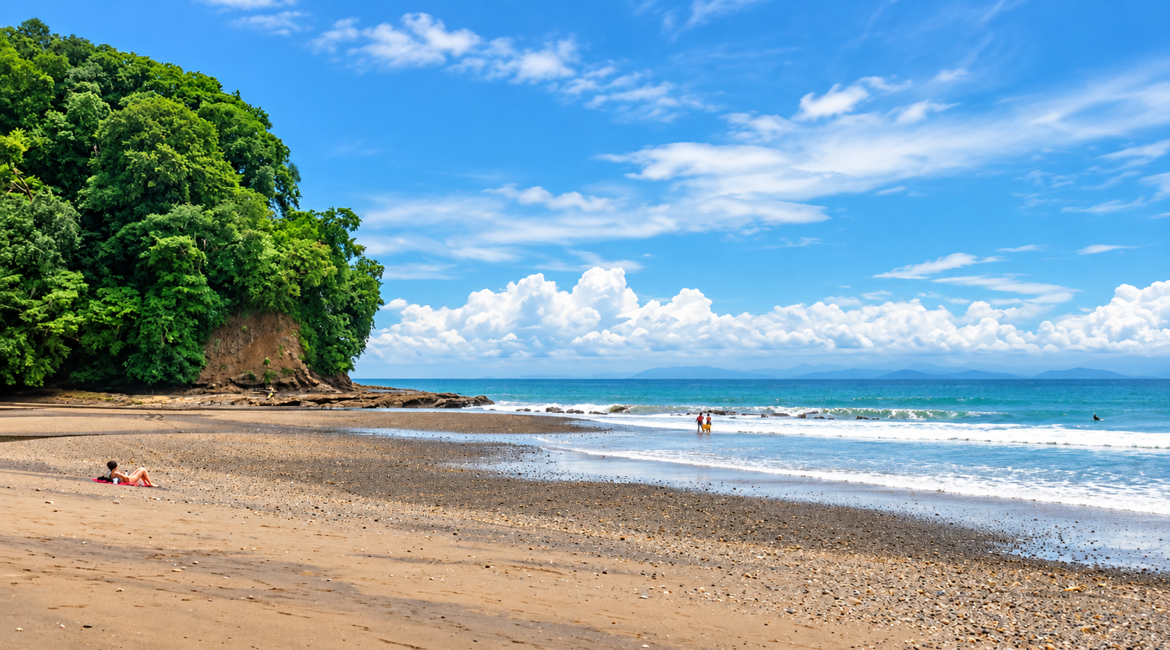 Playa Agujas: a quiet beach with dark sand, gentle waves and green forest behind